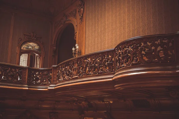 old wooden vintage railing indoors. luxury carved wood interior in the hall of an aristocratic palace. rare architecture. copy space