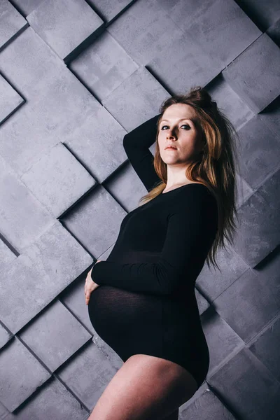 Hamileliğin dokuzuncu ayında büyük göbekli hamile bir kadın beş köşeli büyük bir yıldızın yanında poz veriyor. Doğum beklentisiyle. — Stok fotoğraf