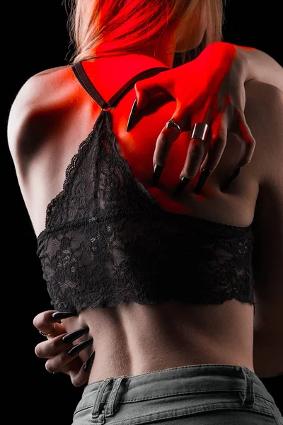 Female hands with long nails hug a thin tender defenseless female body on an isolated black background. self-hatred concept. silver rings on the fingers. sexy slim girl in lace bra — Stock Photo, Image