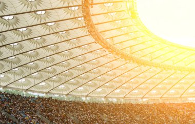 futbol stadyumu içinde görünümü. futbol sahası, boş tribünler, taraftar kalabalığı, gökyüzüne karşı bir çatı