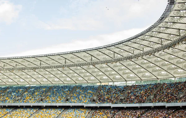 Soccer stadium inside view. football field, empty stands, a crowd of fans, a roof against the sky — Stock Photo, Image