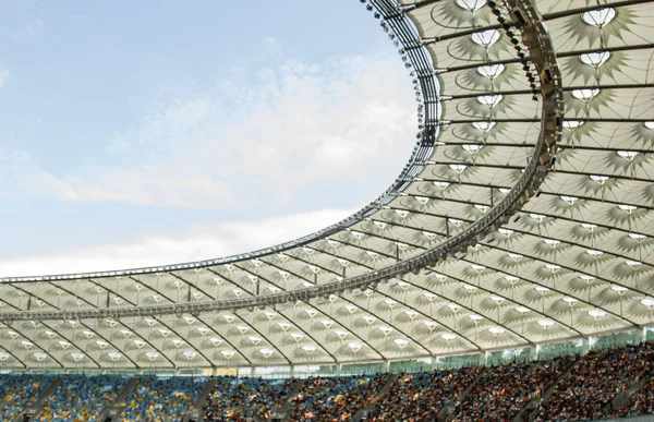 Soccer stadium inside view. football field, empty stands, a crowd of fans, a roof against the sky — Stock Photo, Image