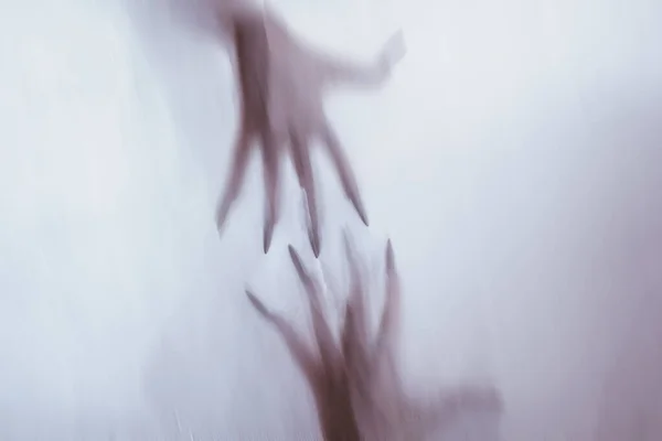 Silhouette of a female sexual figure behind foggy glass. concept of the spirit of poltergeist from the other world. frightening hands of death through the fabric. — Stock Photo, Image