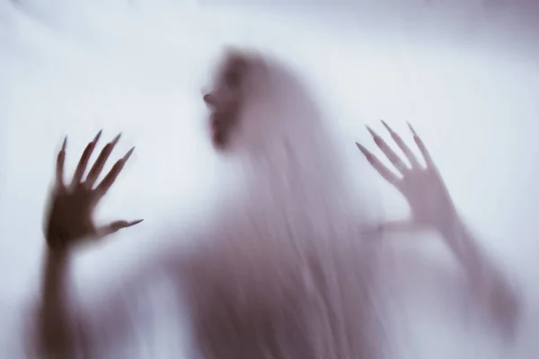 Silhouette of a female sexual figure behind foggy glass. concept of the spirit of poltergeist from the other world. frightening hands of death through the fabric. — Stock Photo, Image