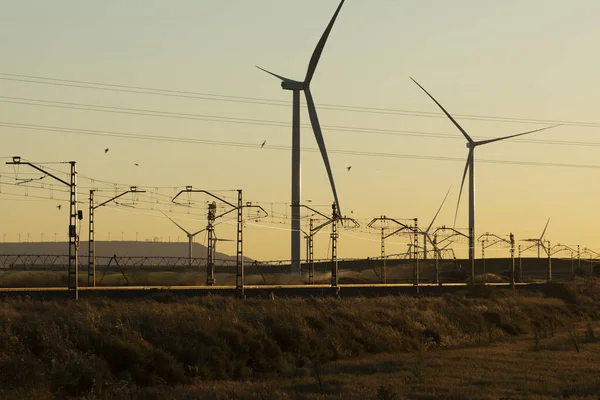 Train tracks superimposed on a landscape of wind turbines in the Ribera Alta del ebro, in Aragon, Spain.