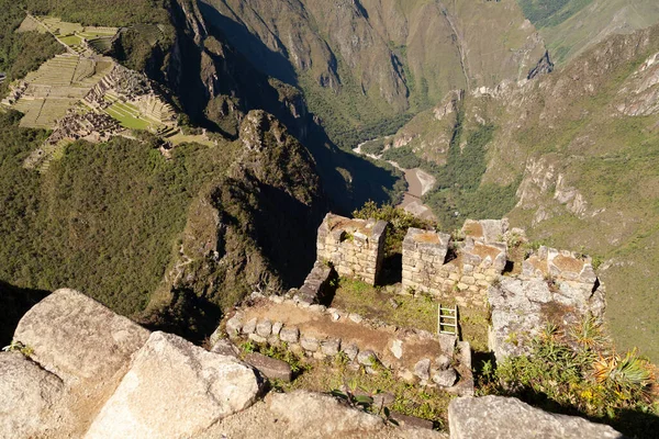 Machu Picchu, Peru - April 6, 2014: View from the top of Machu Picchu, going up to the sacred mountain Huayna Picchu, Peru.