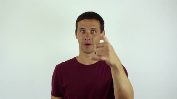 Handsome young man makes a hand gesture with a request to call back. — Stock Video