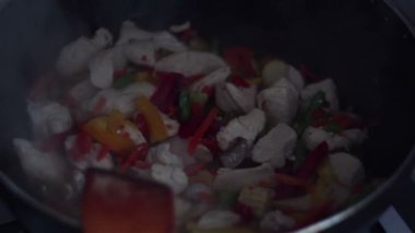 Şef wok tavada sebzeli tavuk karışımları.