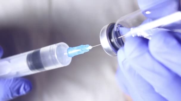 Artsen vullen de injectiespuit met vaccin en bereiden de injectie voor op de patiënt.. — Stockvideo