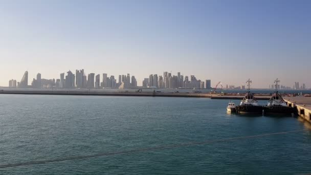 Sea port and view of the city with skyscrapers on the horizon. Sea port with moored ships. — Stock Video