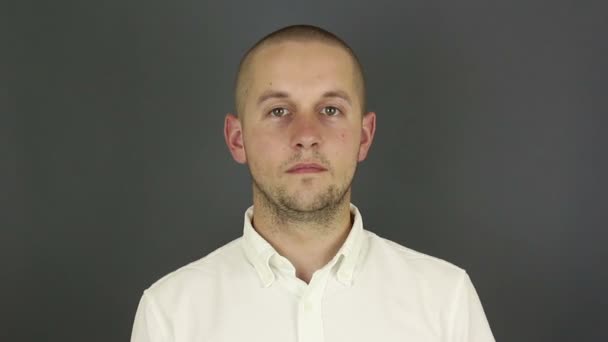 A funny, handsome guy says okay and shows a hand gesture. Portrait, of a young guy, smiles and shows gesture okay. — Stock Video