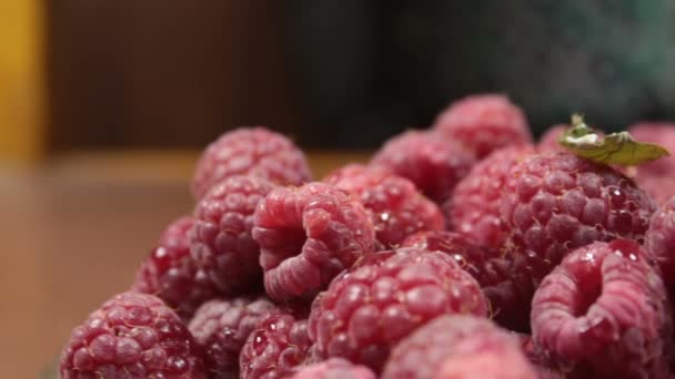 Les framboises juteuses mûres reposent sur une assiette. Gros plan sur les framboises biologiques mûres. — Video