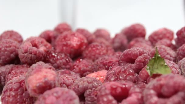 Beautiful female hands take ripe juicy raspberries from a plate. Close-up of hands taking ripe raspberries from a plate. — Stock Video