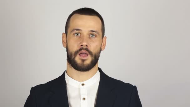 Young handsome businessman in blue suit says goodbye to the client and waves his hand. Young successful businessman waves his hand saying goodbye to clients. — Stock Video