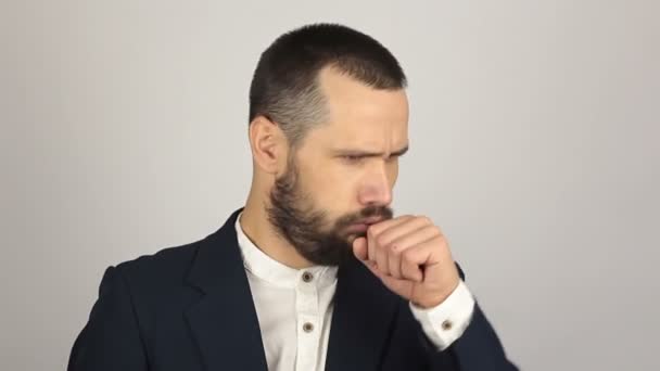 Young handsome businessman coughs badly and feels sick. A Young successful businessman coughs at a meeting. — Stock Video