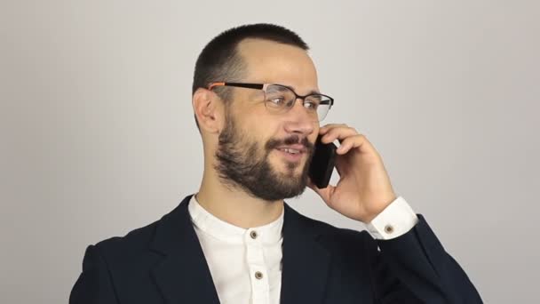 A young successful businessman is talking with partners on a mobile phone. — Stock Video