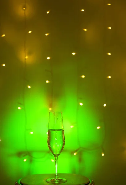 Champagne sparkling wine glass of prosecco cava in discotheque party bar during wedding in Ibiza Spain with lights behind.