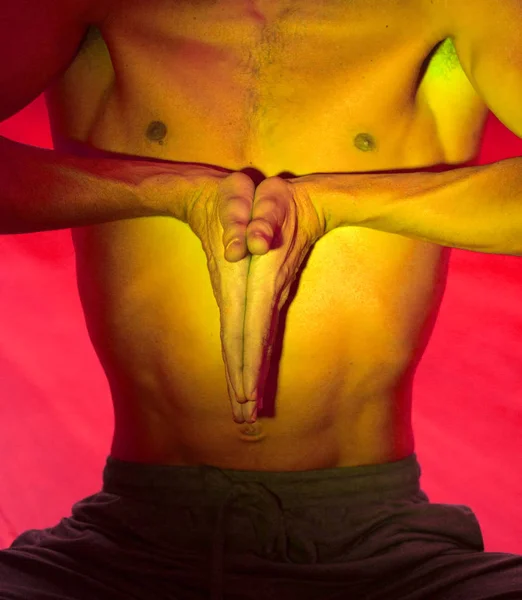 Yoga teacher man doing meditation practice with hand mudra asana.