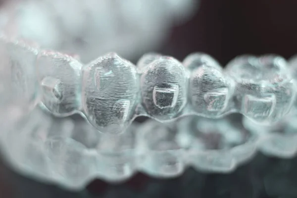 Invisible dental teeth aligners brackets used to align each tooth in cosmetic dentistry for patients.