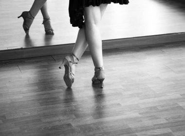 Female ballroom dance salsa dancer instructor woman dancing in shcool rehearsal room clipart