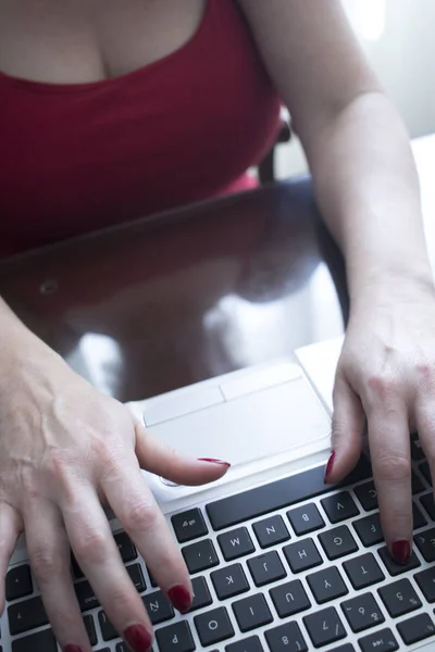 Woman typing on laptop pc