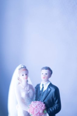 Düğün çifti pasta üstte plastik figürler smokin gece elbisesi, beyaz gelinlik peçesi.