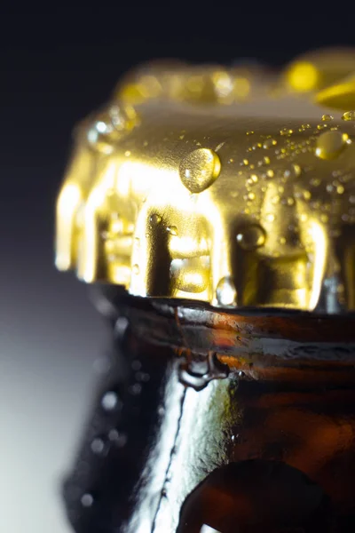 close up beer bottle cap macro on dark background