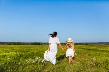 Dikiz anne ve kızı birlikte yeşil alana göre güneşli günde yürüyüş