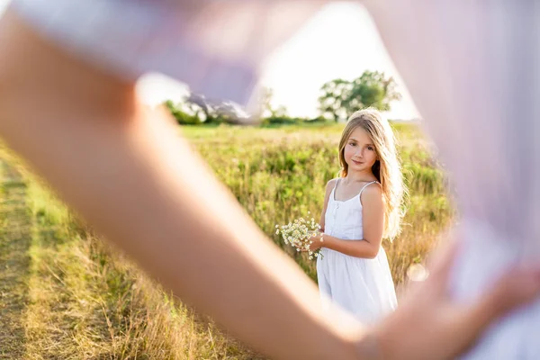 Linda Menina Com Buquê Flores Campo Olhando Para Mãe Desfocada — Fotografia de Stock