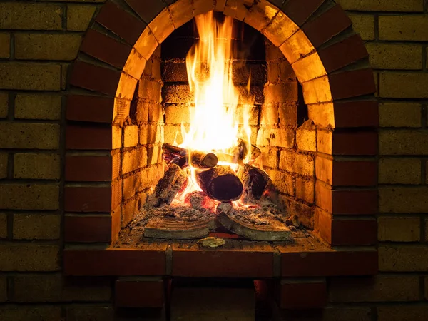 front view of burning woods in fireplace in rural house