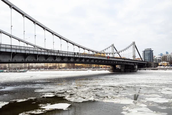 view of Krymsky (Crimean) Bridge over Moskva River with floating ice blocks in Moscow city in winter day. Krymsky Bridge is the only suspension bridge in all of Moscow