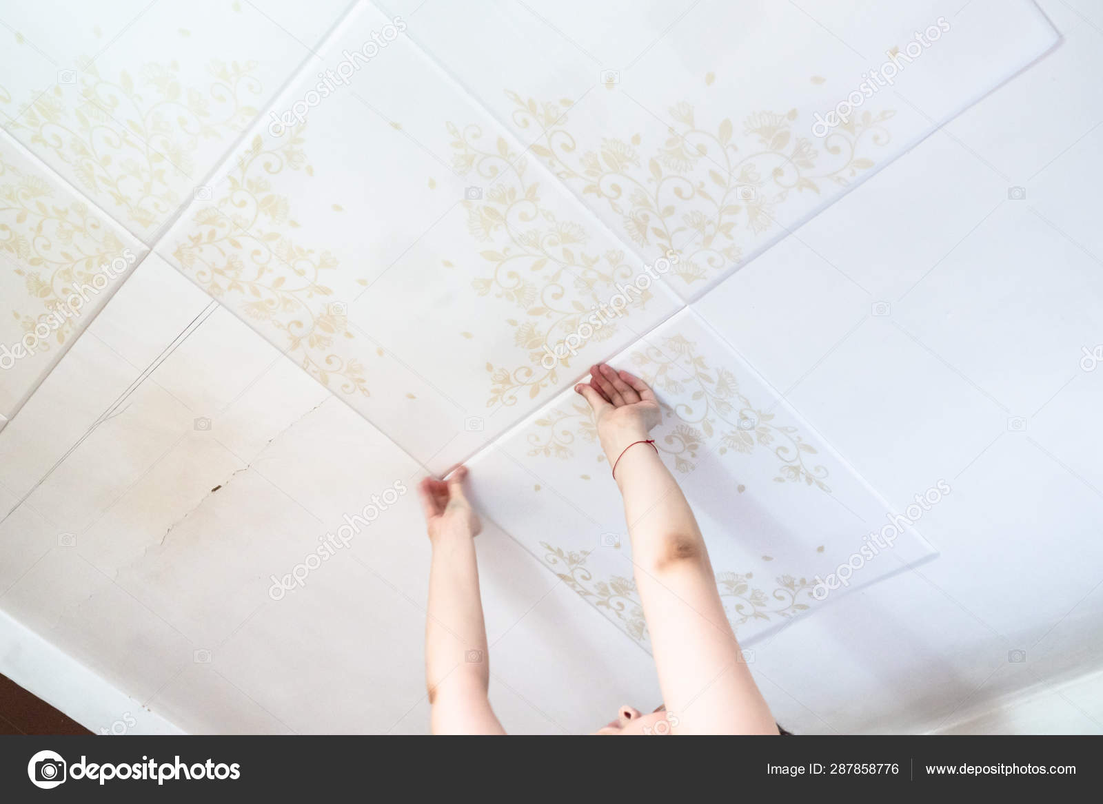 Woman Presses Styrofoam Ceiling Tiles Stock Photo