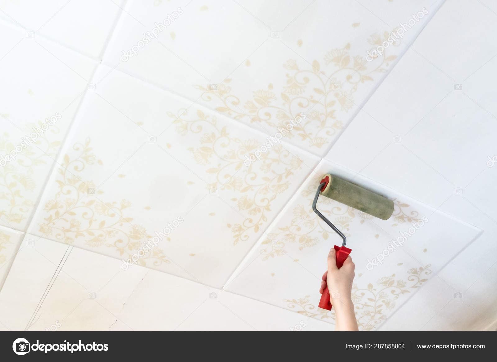 Fixing Styrofoam Ceiling Tiles With Roller Stock Photo