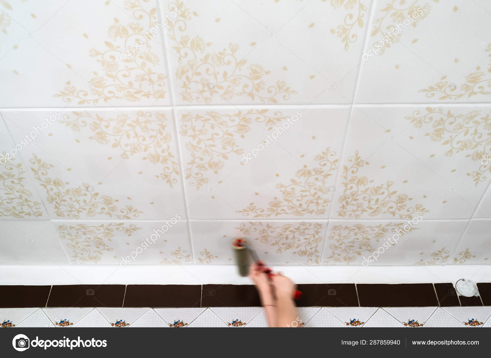 Fixing Styrofoam Ceiling Tiles With Roller Stock Photo