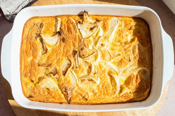 baked omelette with squash in baking dish on board
