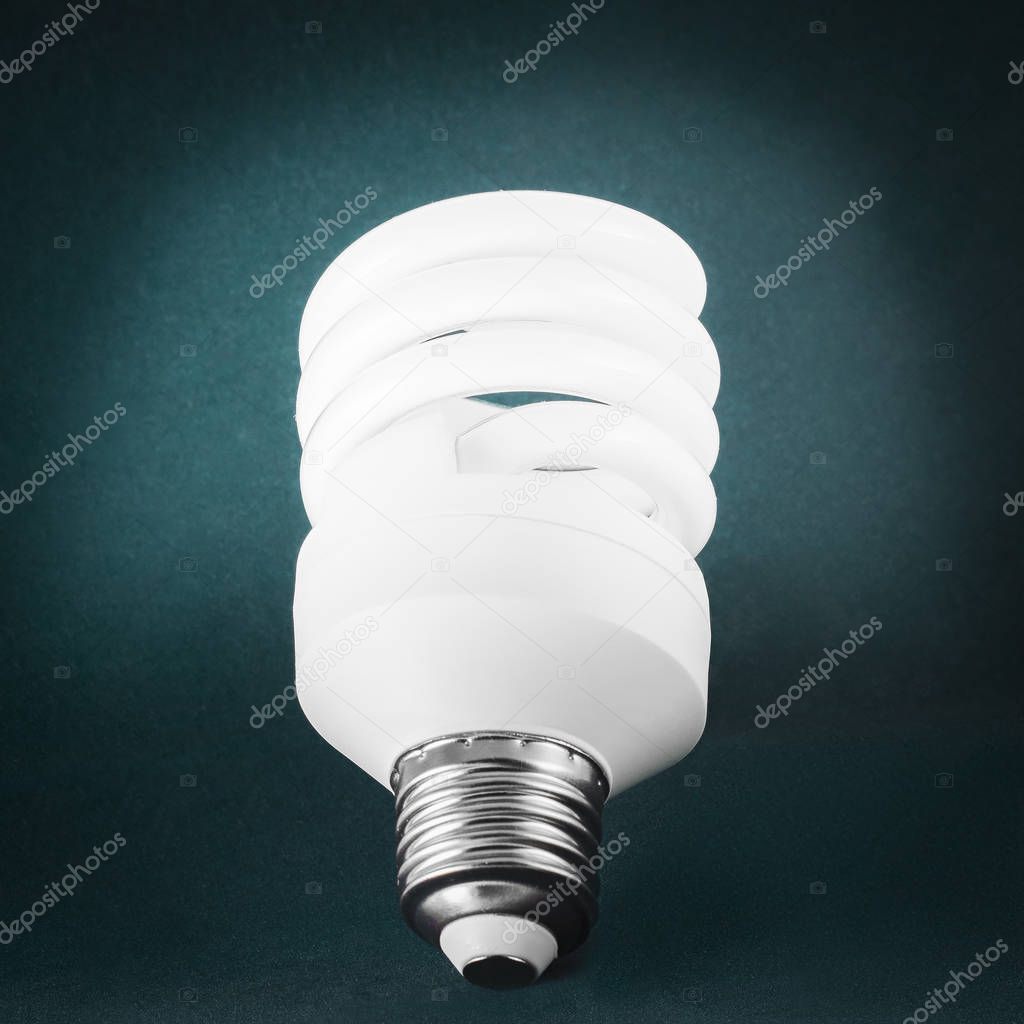 Energy saving light bulb on dark background