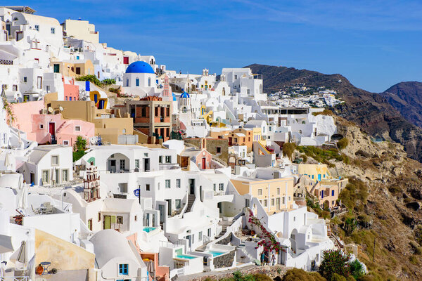 Traditional white buildings facing Aegean Sea in Oia, Santorini island, Greece