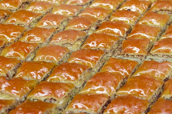 Sweet, juicy, honey, sugar Turkish baklava. Traditional Turkish dessert decorated with pistachios and walnuts. Eastern sweetness, which comes to iftar in holy month of Ramadan. ckground, copy space.