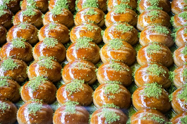 Sweet, juicy, honey, sugar Turkish baklava. Traditional Turkish dessert decorated with pistachios and walnuts. Eastern sweetness, which comes to iftar in holy month of Ramadan. ckground, copy space.