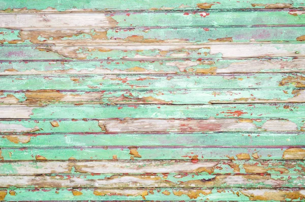 Blue wooden wall. Old turquoise paint. Peeling ultramarine coating on wooden slats. Yary neon colors. Background, copy space.