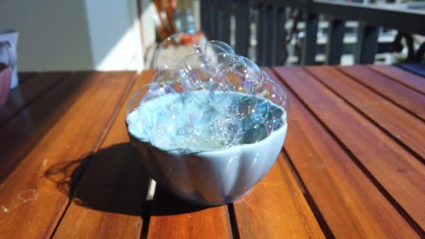 Soap bubbles in cup. Large straws inflate large soap bubbles from soap solution — Stock Video