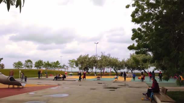 Overcast, cloudy day. modern children's playground in open air on promenade. — Stock Video