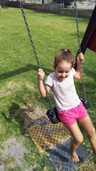 Happy Girl Swinging Playground Grass Stock Photo