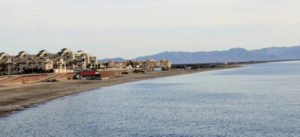 İspanya kıyısında Bina ve dağ arka plan ile kumsalda