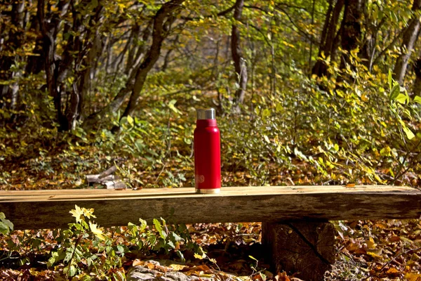 Rest in the autumn forest. Picnic with meat, hot tea on the fire. Halt and rest in the fall in nature.