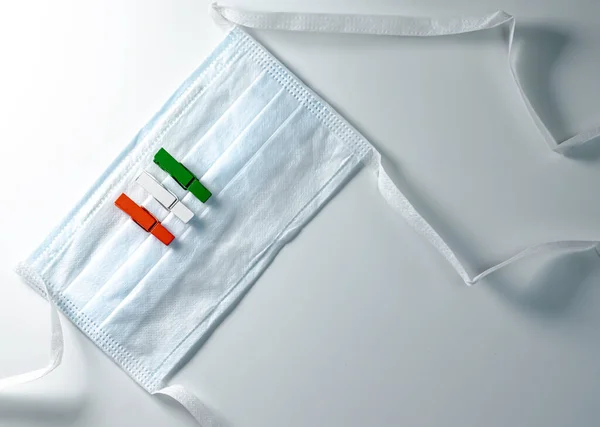 Hint bağımsızlığını temsil eden turuncu beyaz ve yeşil tahta klipsli cerrahi maske. 