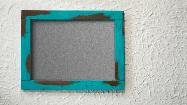 A grungy wooden frame with textured with concrete background and copy space