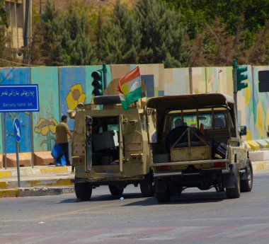 Kurdish Peshmerga soldiers blocking road outside Erbil Governorate building under Islamic State attack in Iraqi-Kurdistan on 23rd July 2018. Kurdish security forces neutralized all three Daesh terrorists. clipart