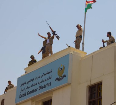 Kurdish Soldiers on top a building opposite Erbil's Governorate that Islamic State gunmen attacked in Iraqi-Kurdistan on 23rd July 2018. Kurdish security forces neutralized all three Daesh terrorists. clipart