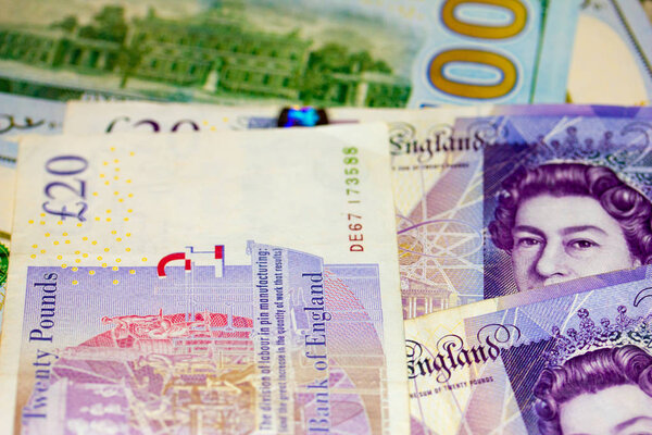 Двадцать фунтов британских нот и сто долларов США
